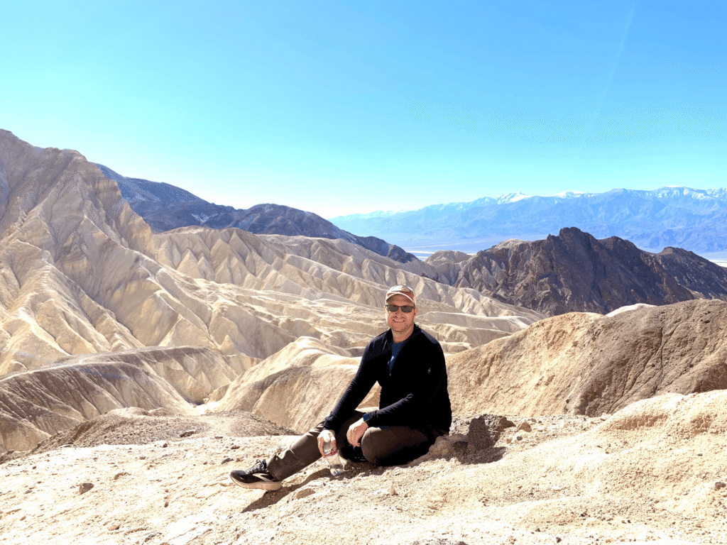 Josh Aversa sits in a natural landscape in Death Valley National Park